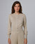 Woman wearing Juana Liora Knitted Hemp Cardigan in beige merino–silk–hemp blend, styled for sustainable everyday wear.