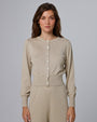 Woman wearing Juana Liora Knitted Hemp Cardigan in beige merino–silk–hemp blend, styled for sustainable everyday wear.