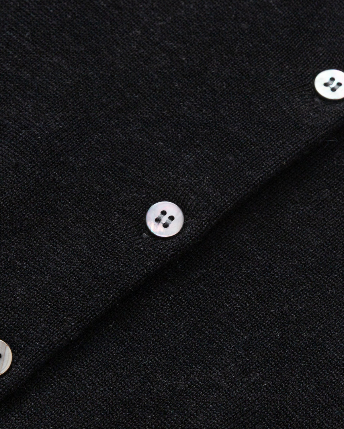 Flat lay of Liora Knitted Hemp Cardigan (black), showing knit structure and finishing.