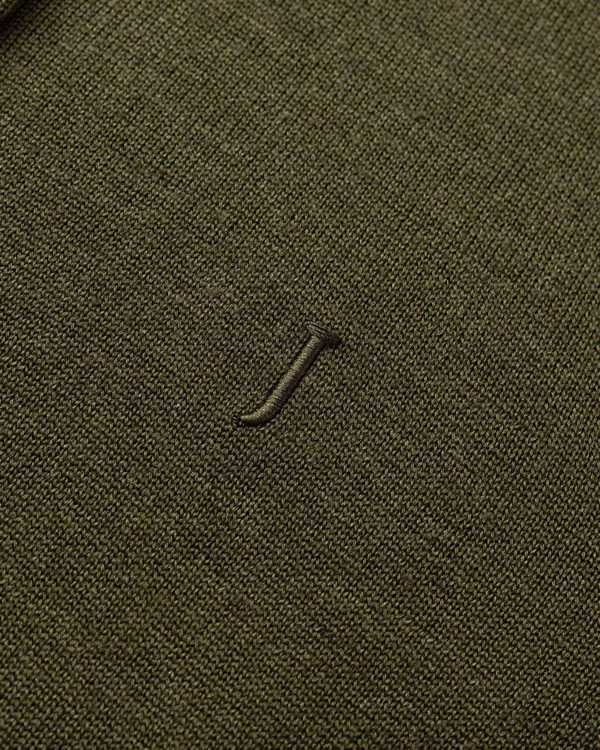 Flat lay of Liora Knitted Hemp Cardigan (camo green), showing knit structure and embroideries finishing.
