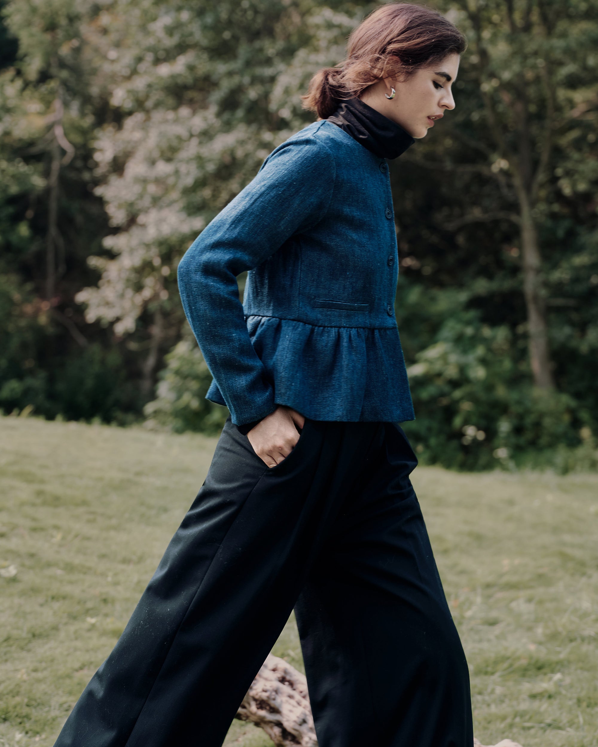 Layered styling: Peplum Jacket (blue denim) over Ossa Turtleneck (black) with tailored trousers for modern, feminine polish.