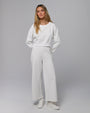 Model wearing coordinated white fleece set (cropped sweater + sweatpants); front view.
