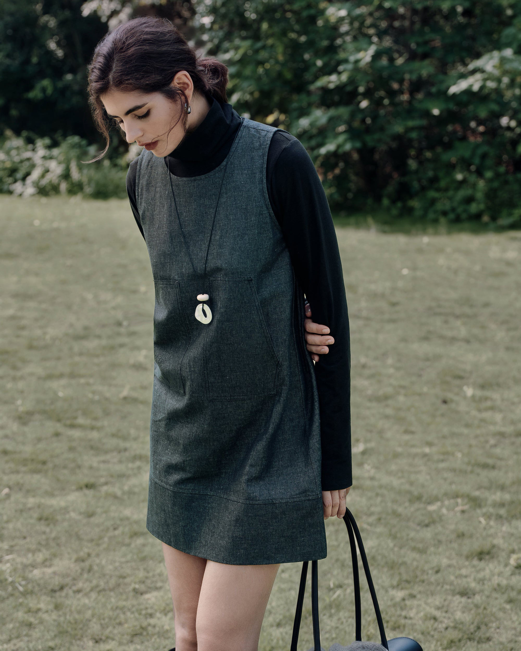 Refined casual: Mockneck (black) with Shift Dress (black denim) and a tailored coat for modern, sustainable style.