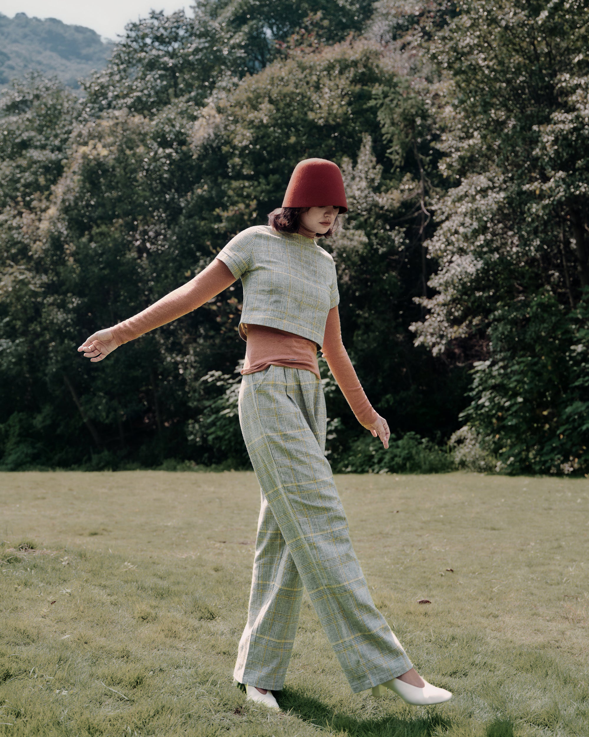 Refined casual: Ossa Turtleneck (Mocha Mousse) with Plaid Theory Top (yellow–grey plaid) and denim for a modern mix of textures.