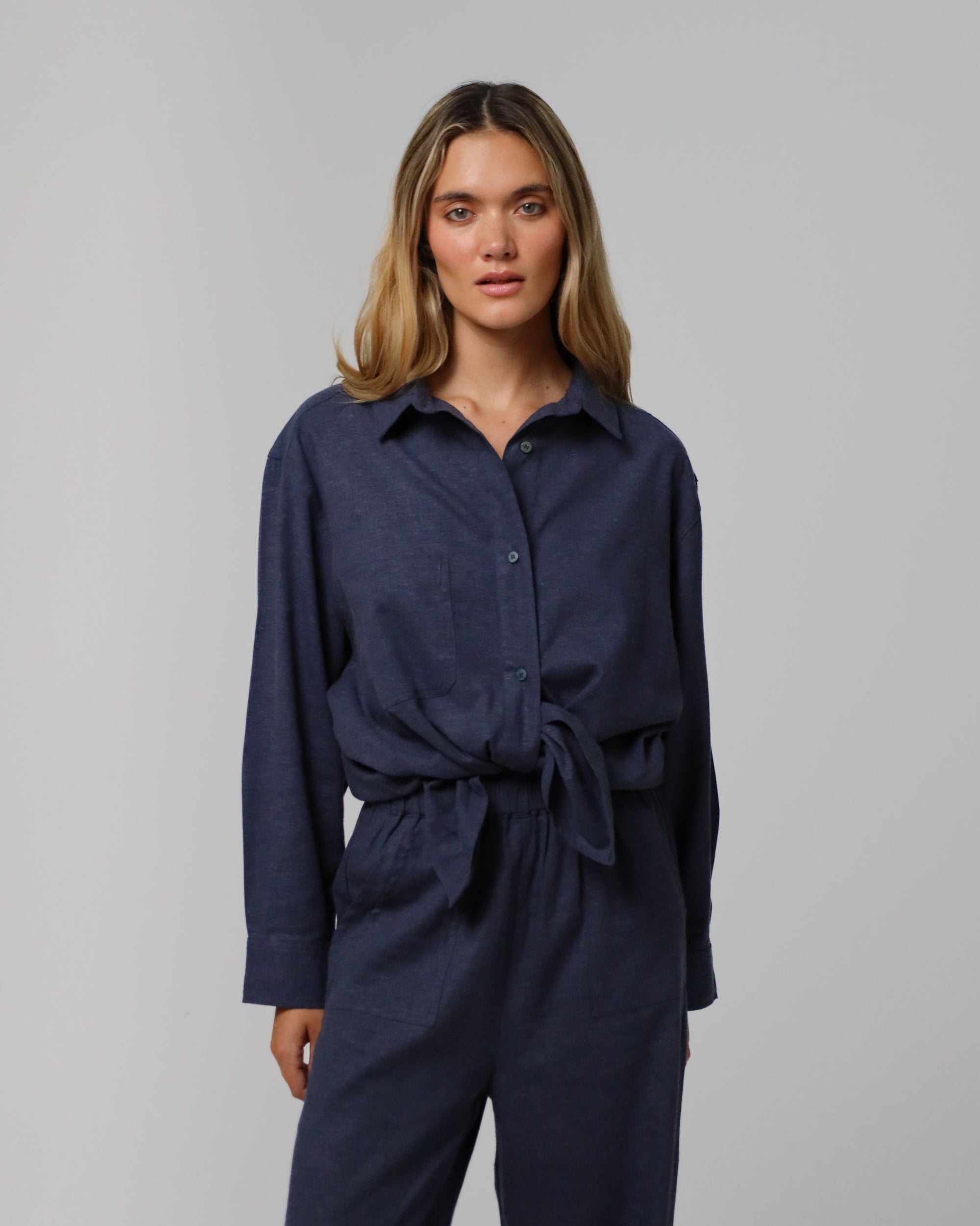 Detail shot of corozo buttons and stitching on the Lyricist Oversized Shirt in indigo blue.