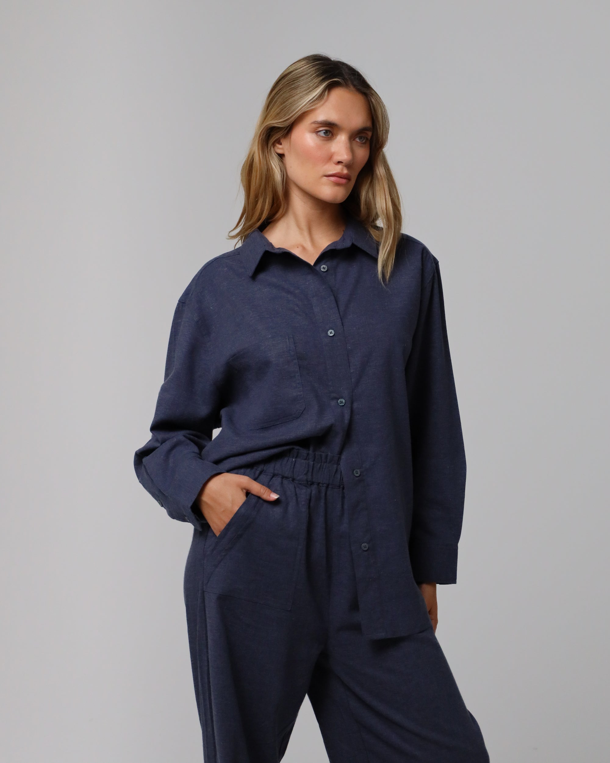 Woman wearing Juana Lyricist Oversized Shirt in an indigo blue hemp–Tencel™ twill blend, styled for sustainable everyday wear.