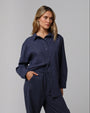 Woman wearing Juana Lyricist Oversized Shirt in an indigo blue hemp–Tencel™ twill blend, styled for sustainable everyday wear.
