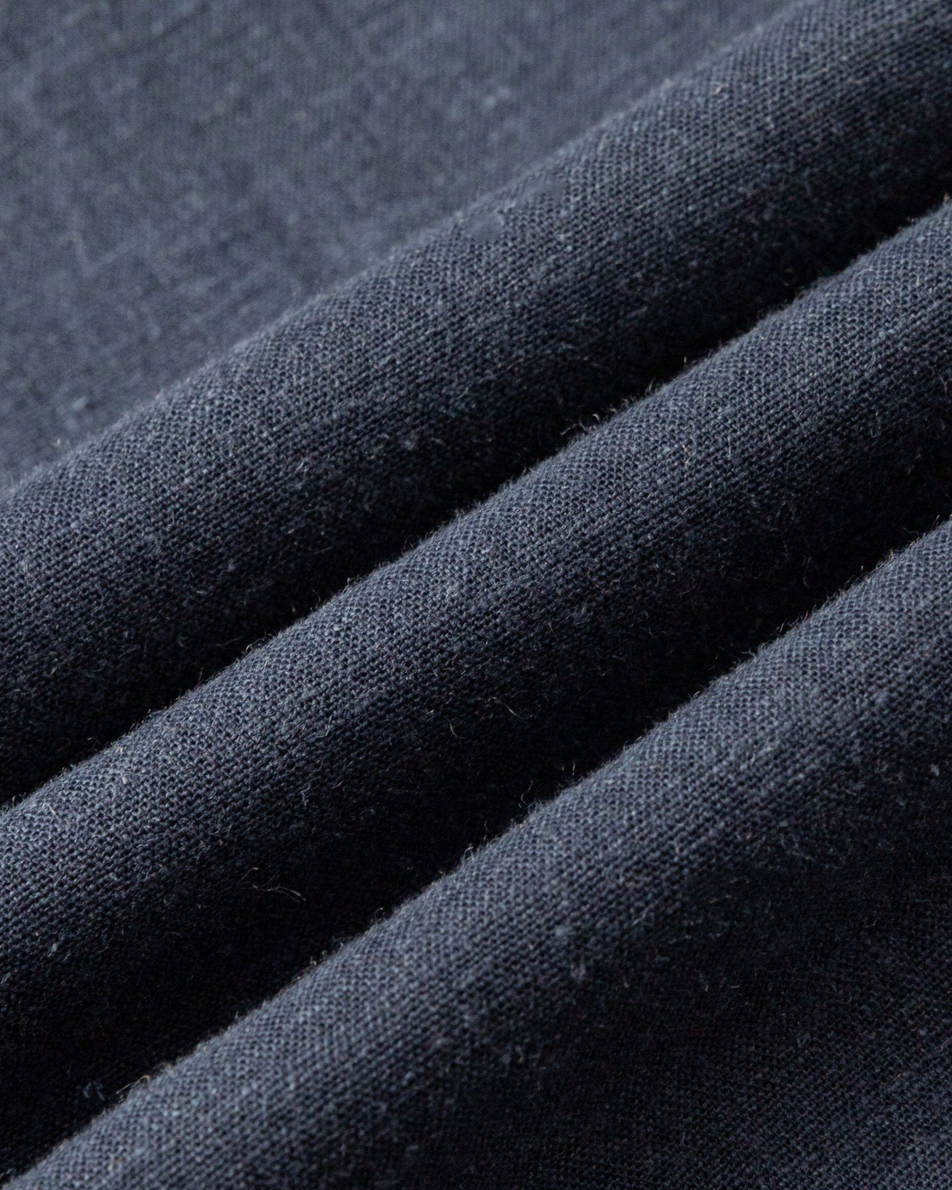 Close-up of indigo blue hemp–Tencel™ twill fabric of Lyricist Oversized Shirt, highlighting soft hand and subtle sheen.