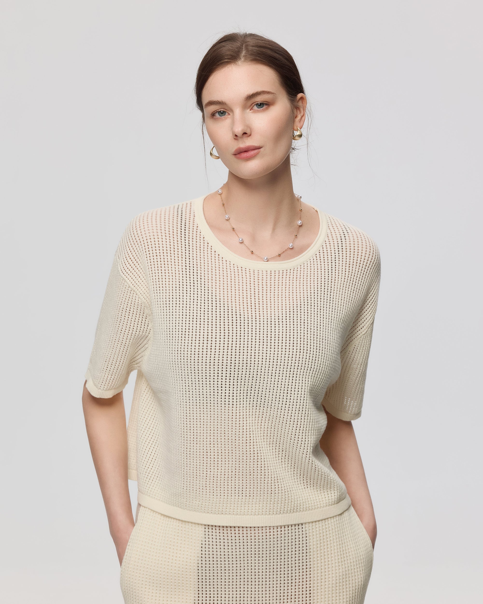 Juana Marina Crochet Tee Cream (sustainable cotton–hemp) styled on model as a lightweight semi-sheer layer