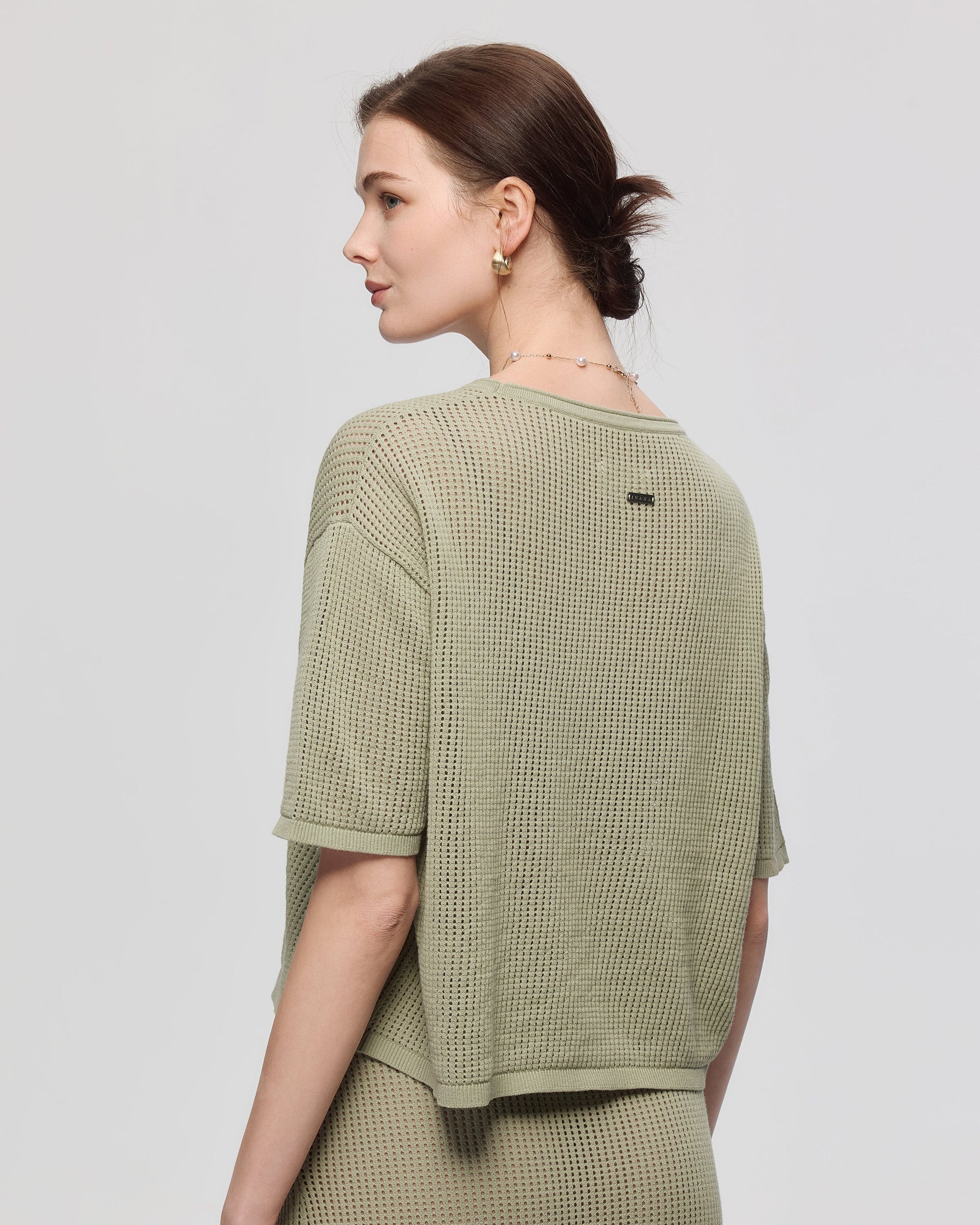 Juana Marina Crochet Tee Sage (sustainable cotton–hemp) back view on model showing boxy silhouette and airy knit