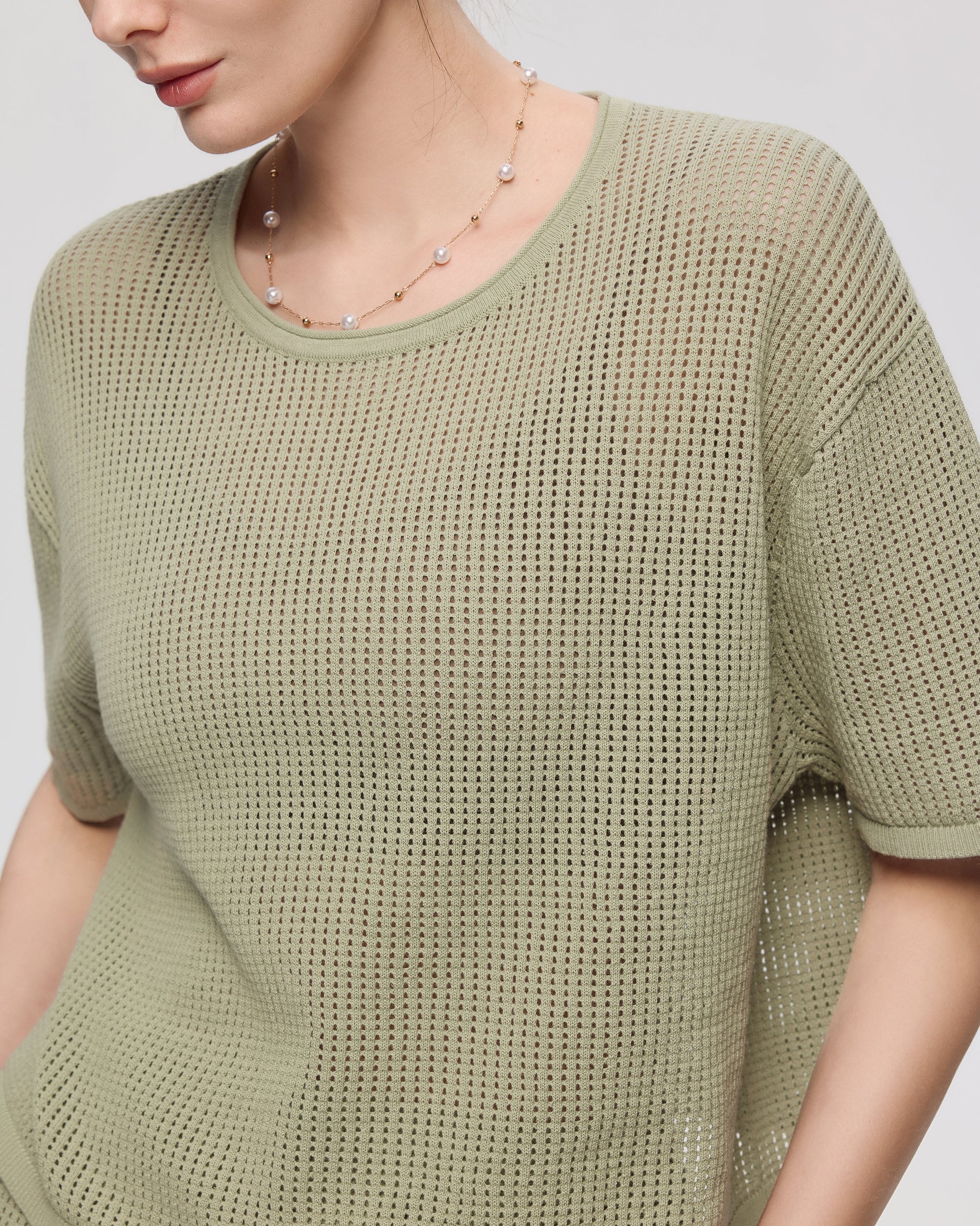 Juana Marina Crochet Tee Sage (sustainable cotton–hemp) detail view showing crochet stitch and crewneck finishing