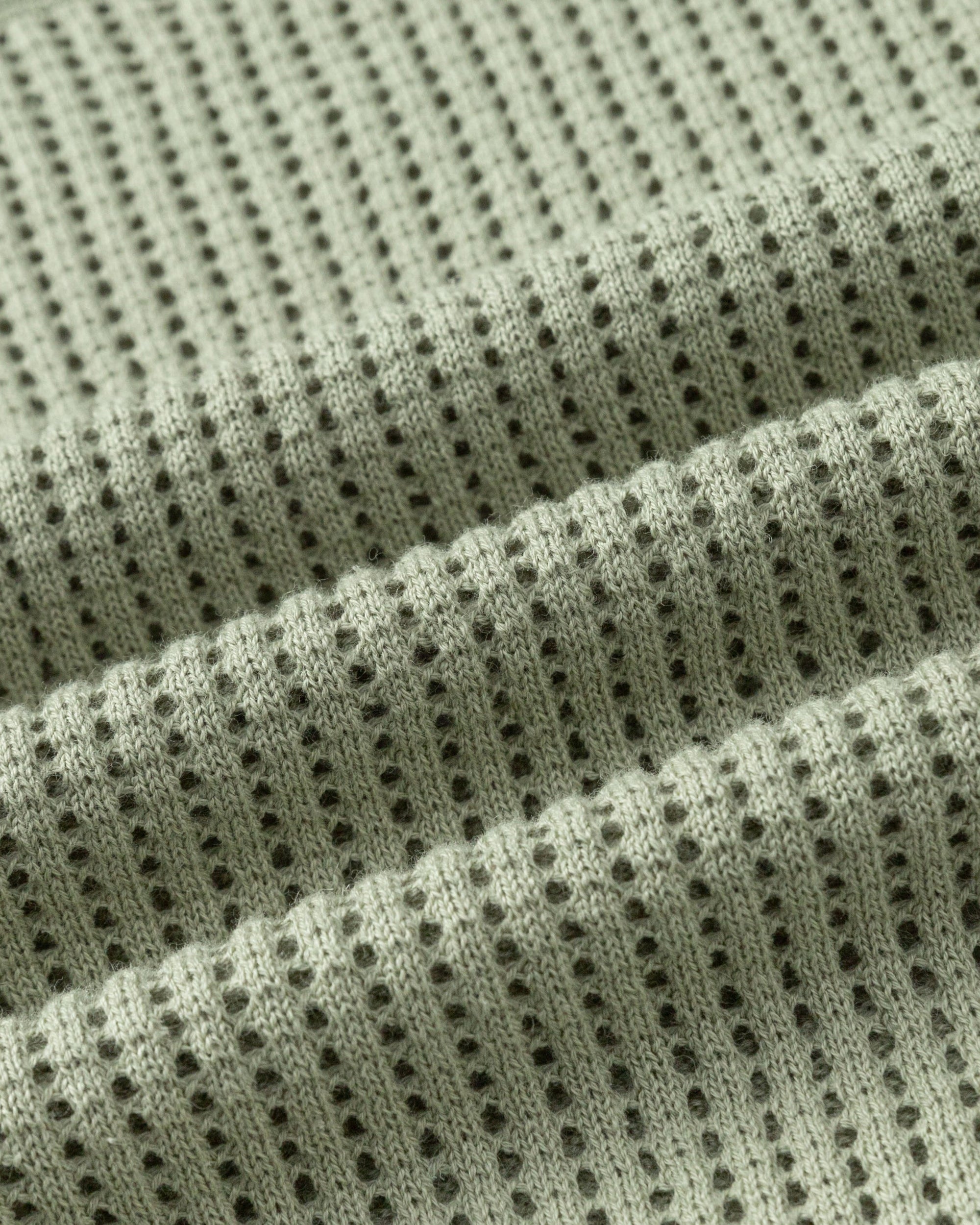 Juana Marina Crochet Tee Sage (sustainable cotton–hemp) textile swatch highlighting airy crochet knit construction