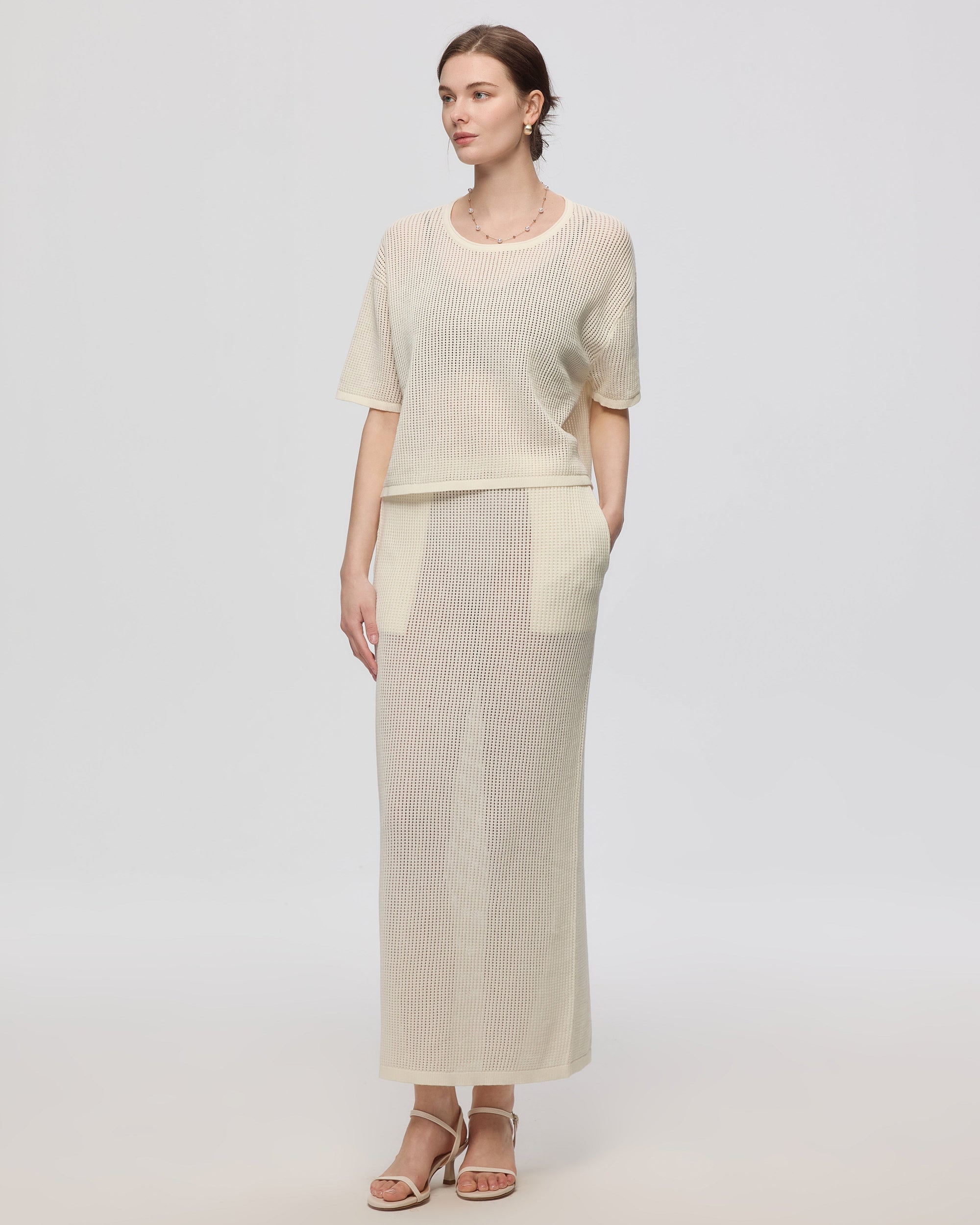 Juana Marina Open Knit Skirt Cream (sustainable cotton–hemp) on model showing swim layering styling and pull-on waist