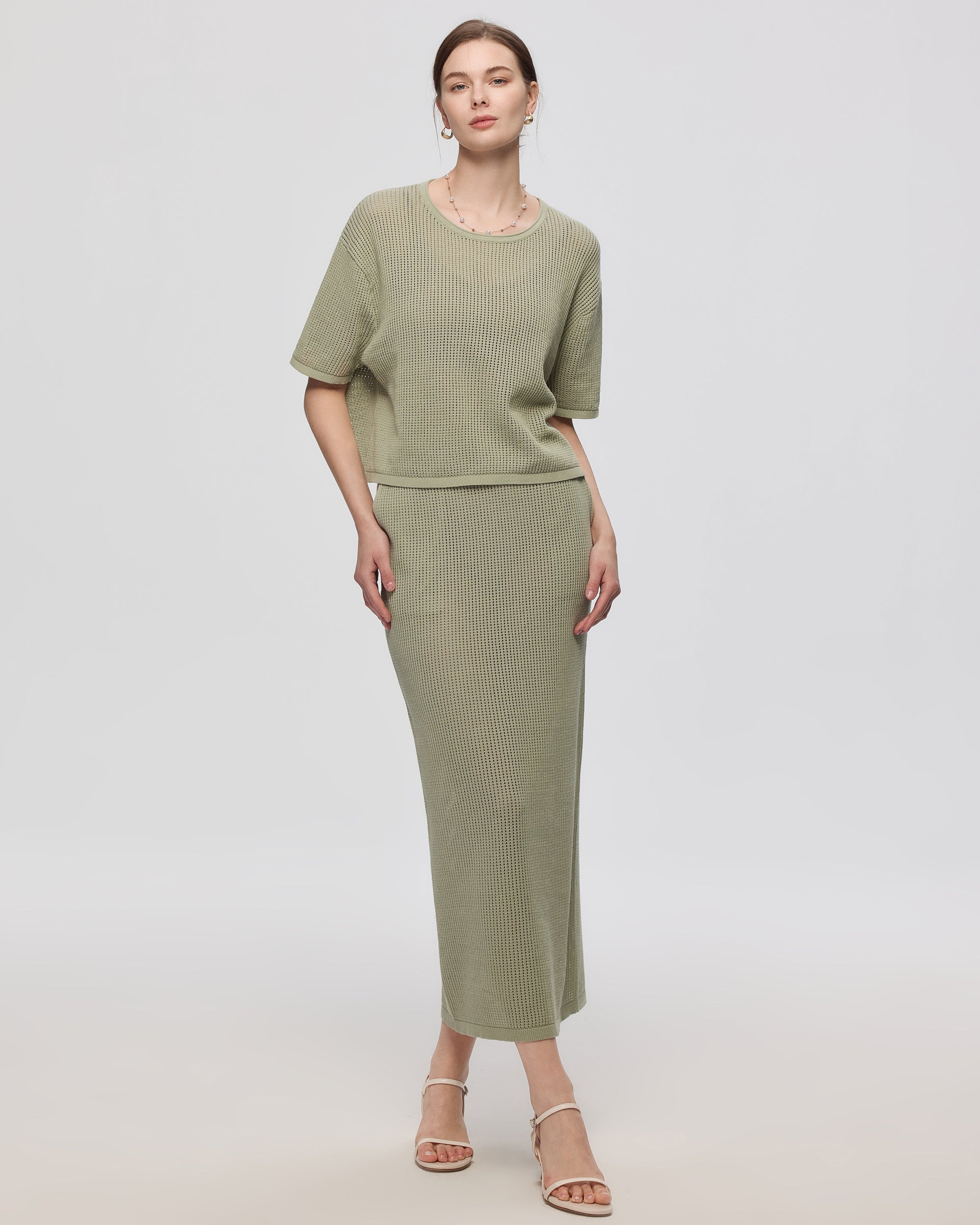 Juana Marina Open Knit Skirt Sage (sustainable cotton–hemp) on model showing swim layering styling and pull-on waist
