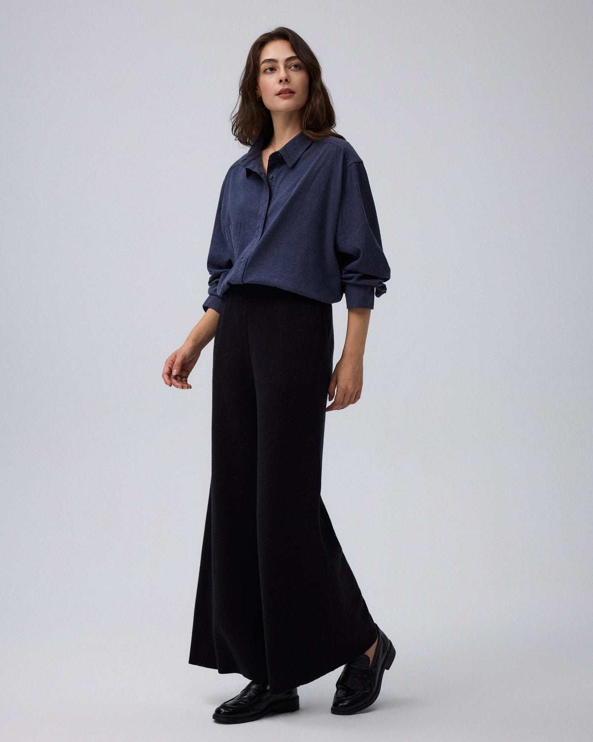 Juana Mid-Rise Cropped Pants in Black (merino wool–hemp–silk) shown on a model from the front with the wide-leg shape visible.