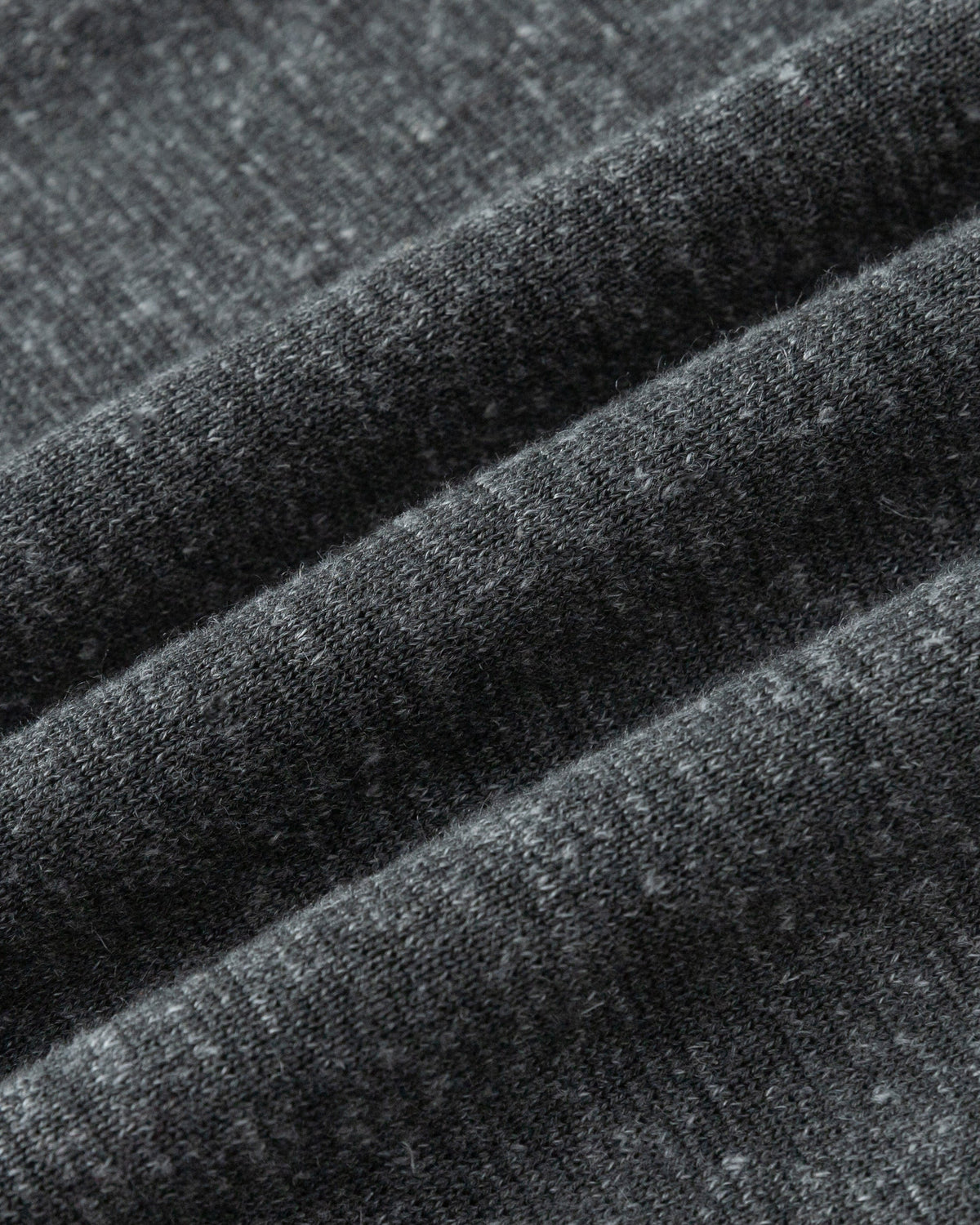 Juana Mid-Rise Cropped Pants in Charcoal (merino wool–hemp–silk) shown in a close-up of the heavyweight sweater-knit texture.