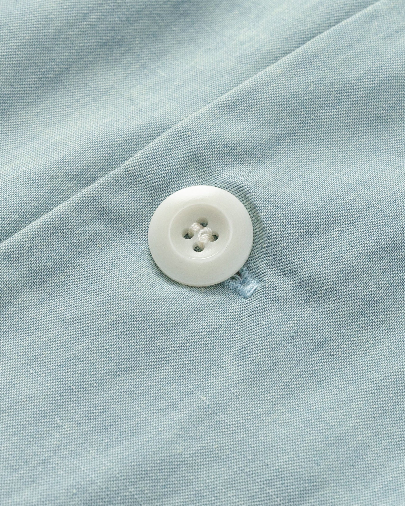 Juana Nahla Jumpsuit chambray blue (tencel–cotton–hemp) layflat detail showing corozo buttons and twill texture