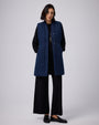 Juana Natural Fill Puffer Vest Dark Wash (organic cotton–hemp) styled in a complete layered look with an adjustable waist
