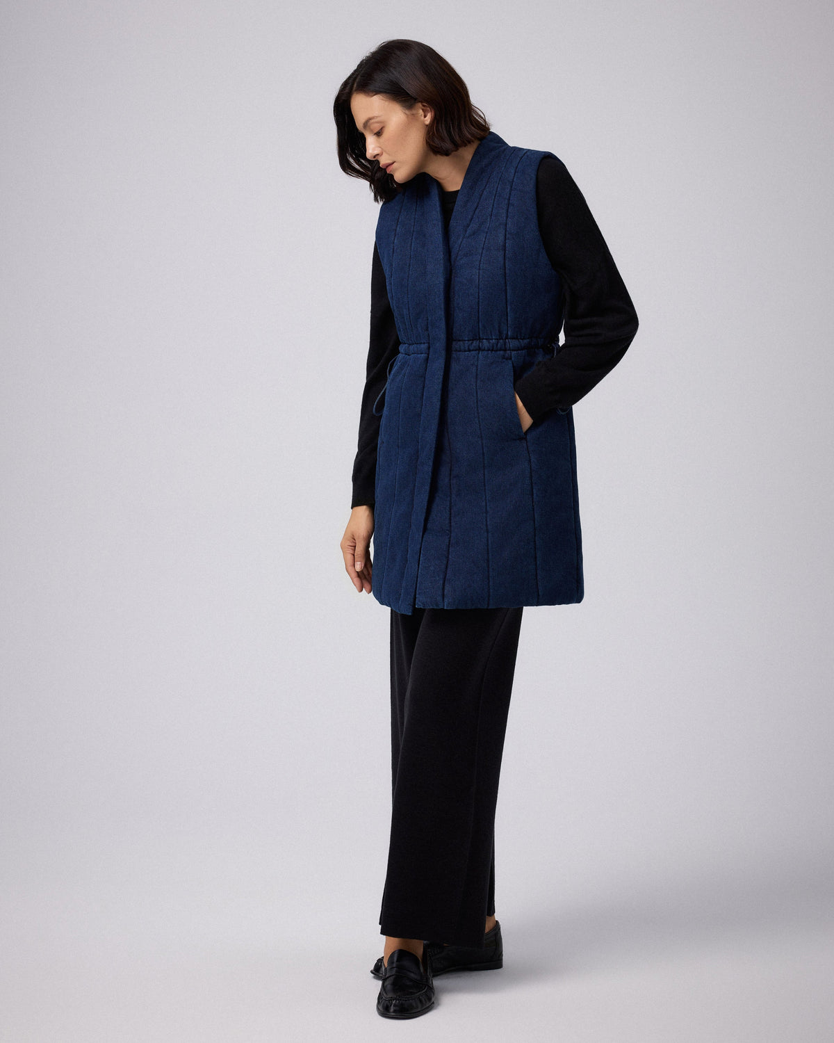 Juana Natural Fill Puffer Vest Dark Wash (organic cotton–hemp) worn on a model with the quilted front and snap closure visible