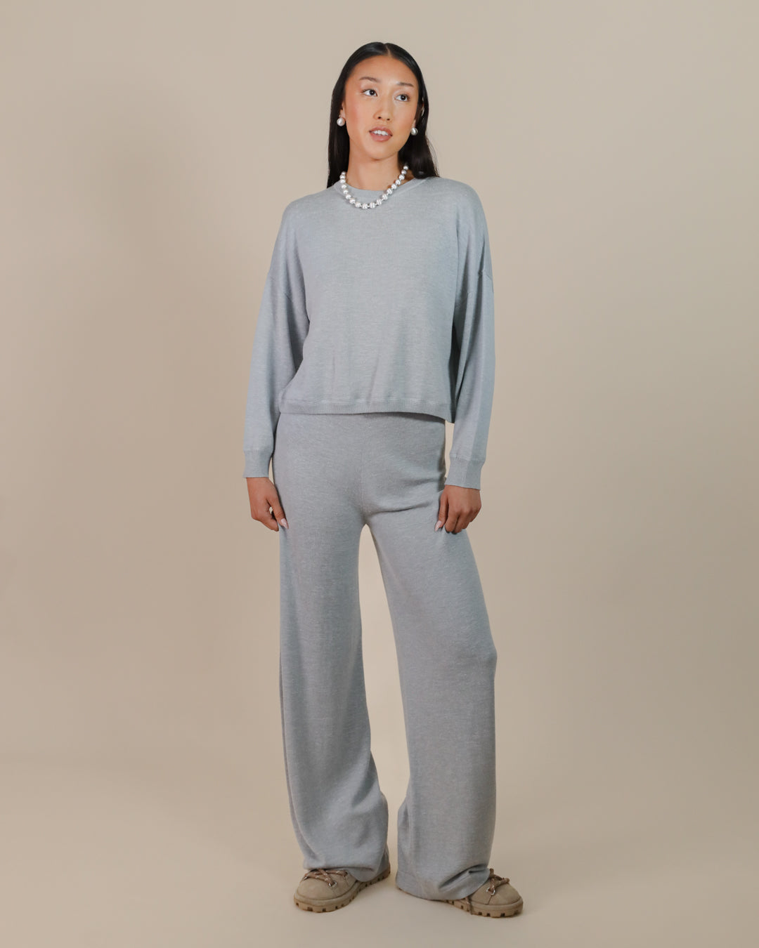 Woman wearing Juana Nilo Knitted Hemp Pull-on Pants in a relaxed setting, showcasing sustainable loungewear.