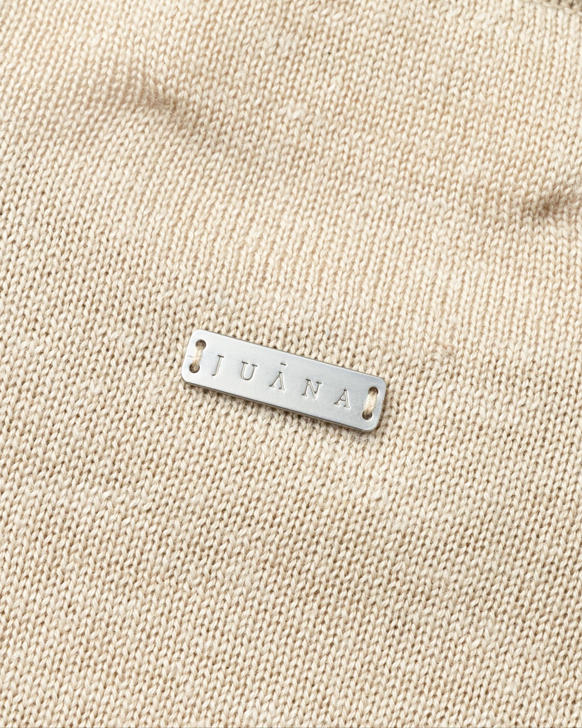 Flat lay of Nilo Knitted Hemp Crewneck (beige), showing knit texture and detail.