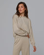 Woman wearing Juana Nilo Knitted Hemp Crewneck in beige merino–silk–hemp blend, styled for sustainable everyday wear.