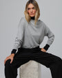 Woman wearing Juana Nilo Knitted Hemp Crewneck in heather gray merino–silk–hemp blend, styled for sustainable everyday wear.