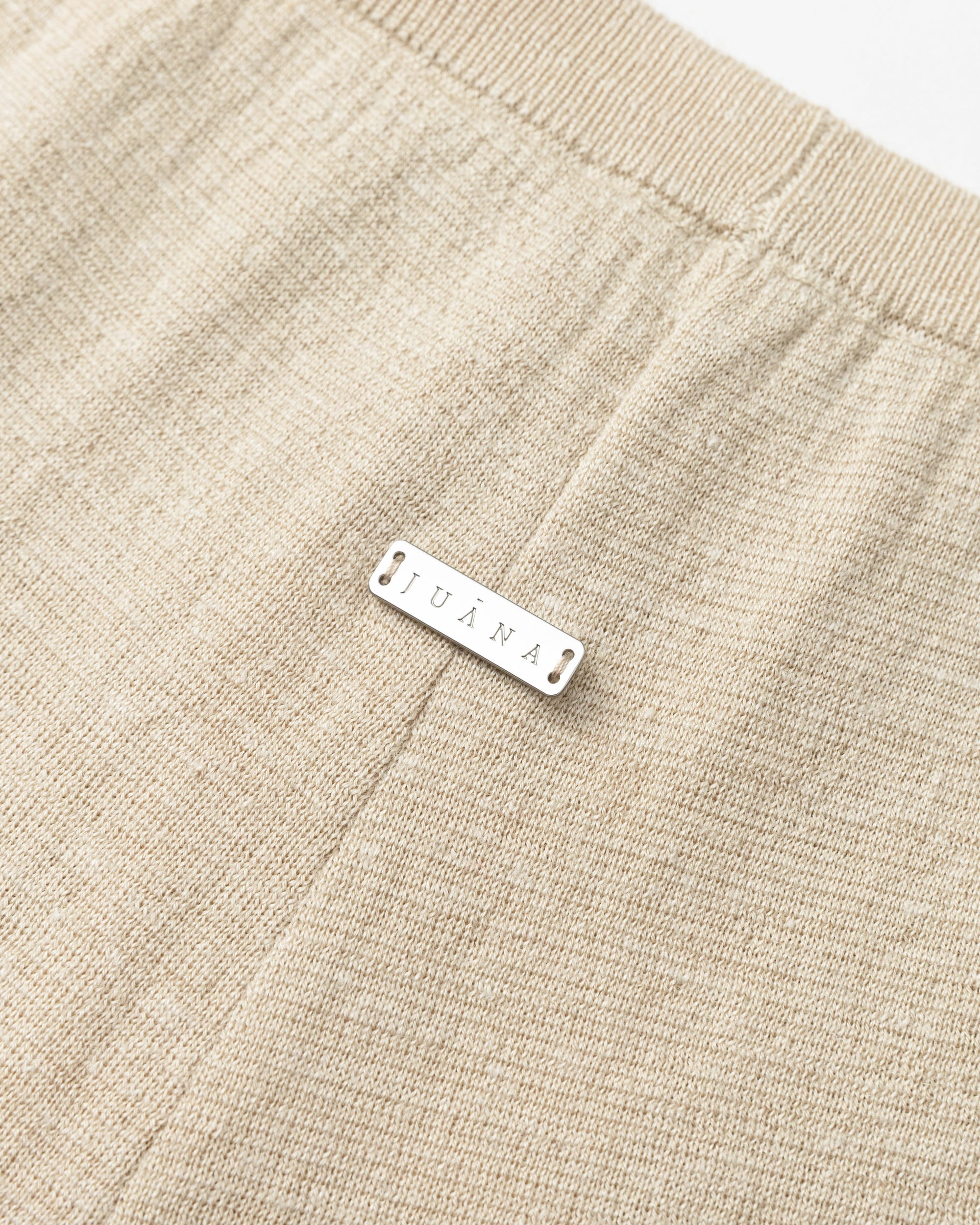 Flat lay of Nilo Knitted Hemp Pull-on Pants (beige), showing knit structure and finishing.
