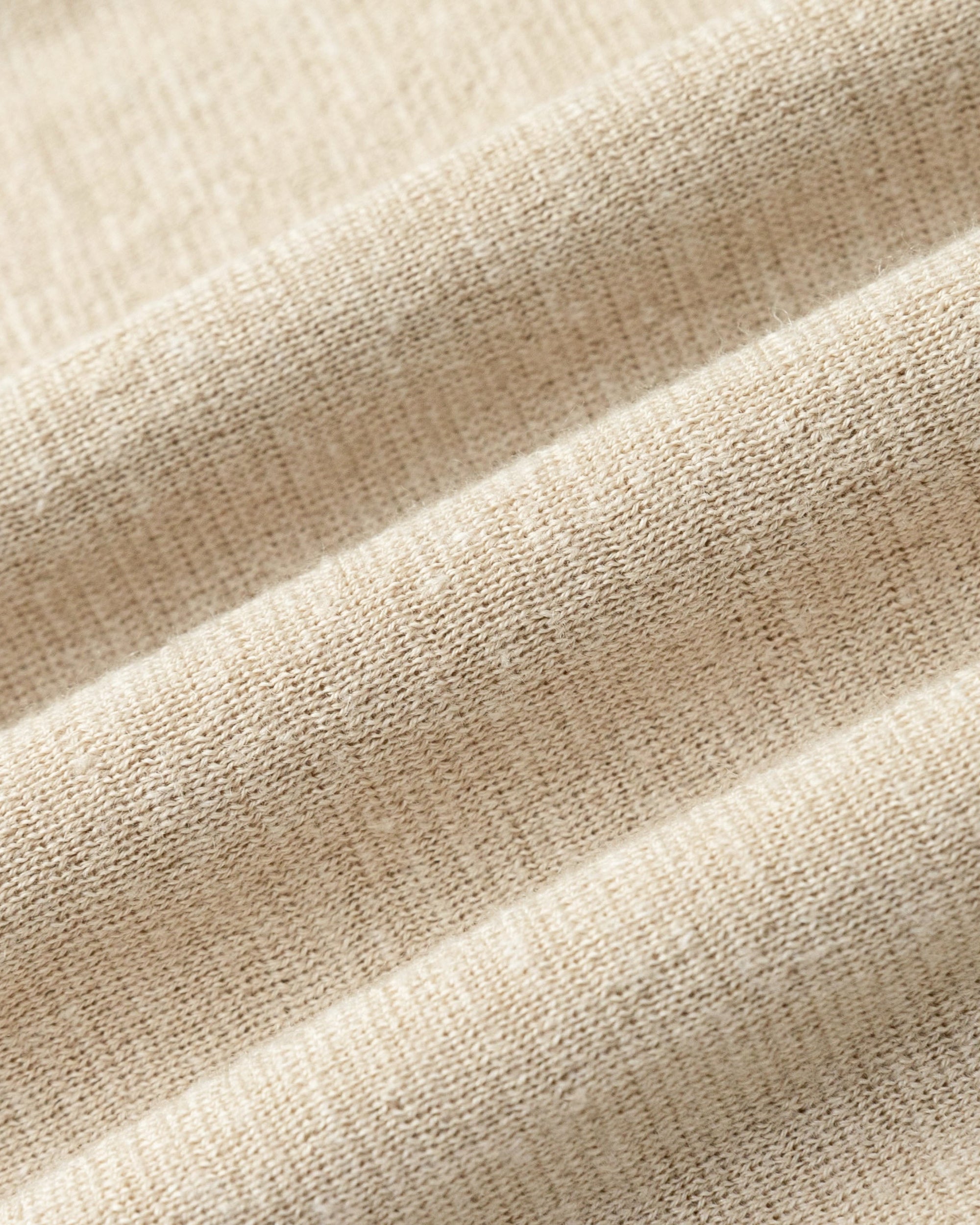 Close-up of merino–silk–hemp sweater knit of Nilo Pull-on Pants (beige), highlighting breathable texture.