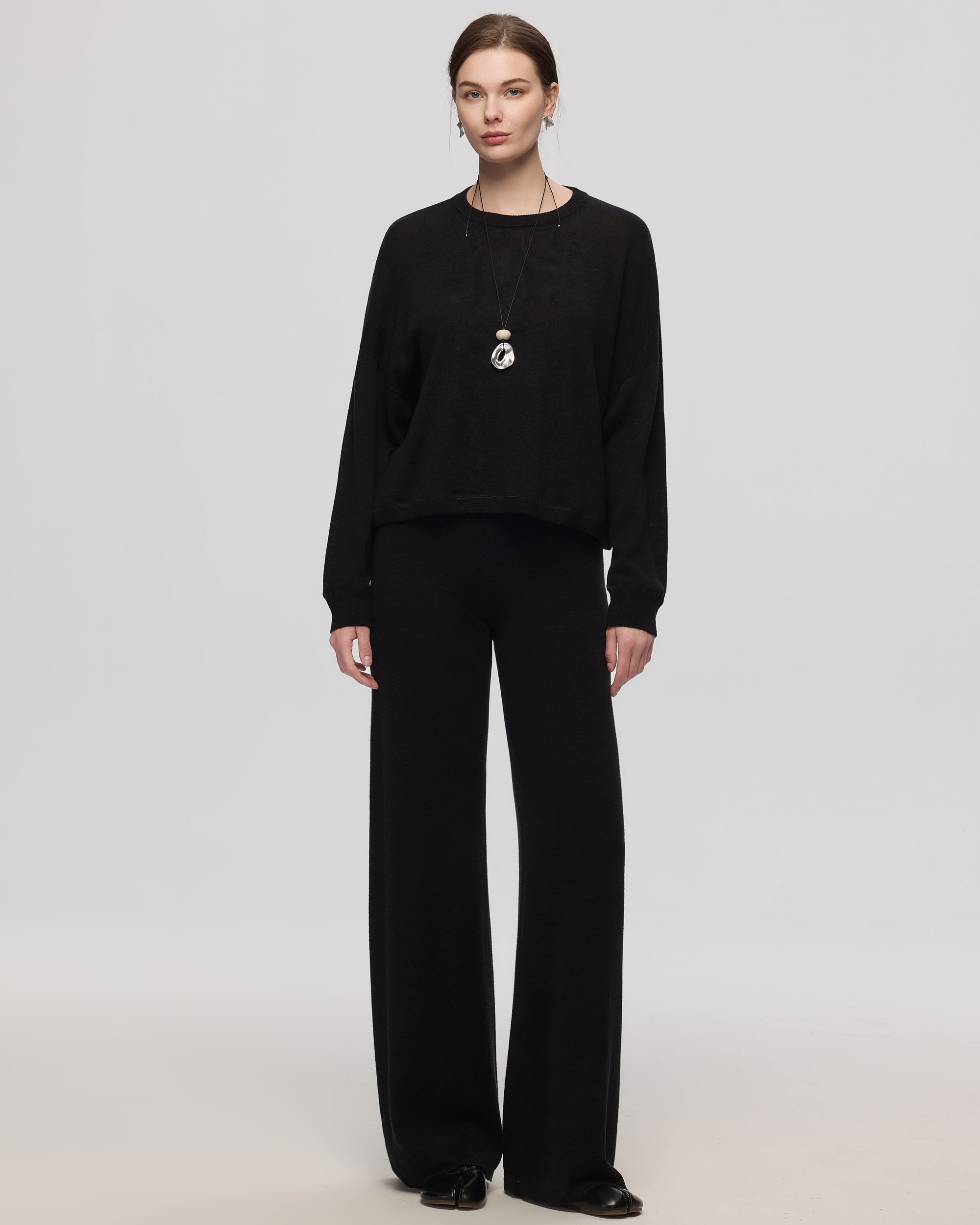 Full-body view of Nilo Knitted Hemp Pull-On Pants (black) paired with matching knit crewneck.