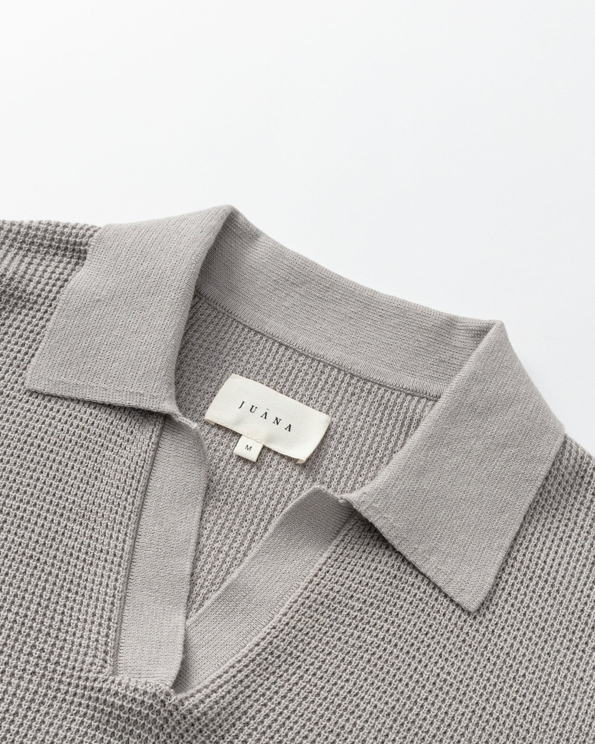 Juana Noa Open Knit Top light gray (sustainable cotton–hemp) shown as a flat lay with airy open-knit texture