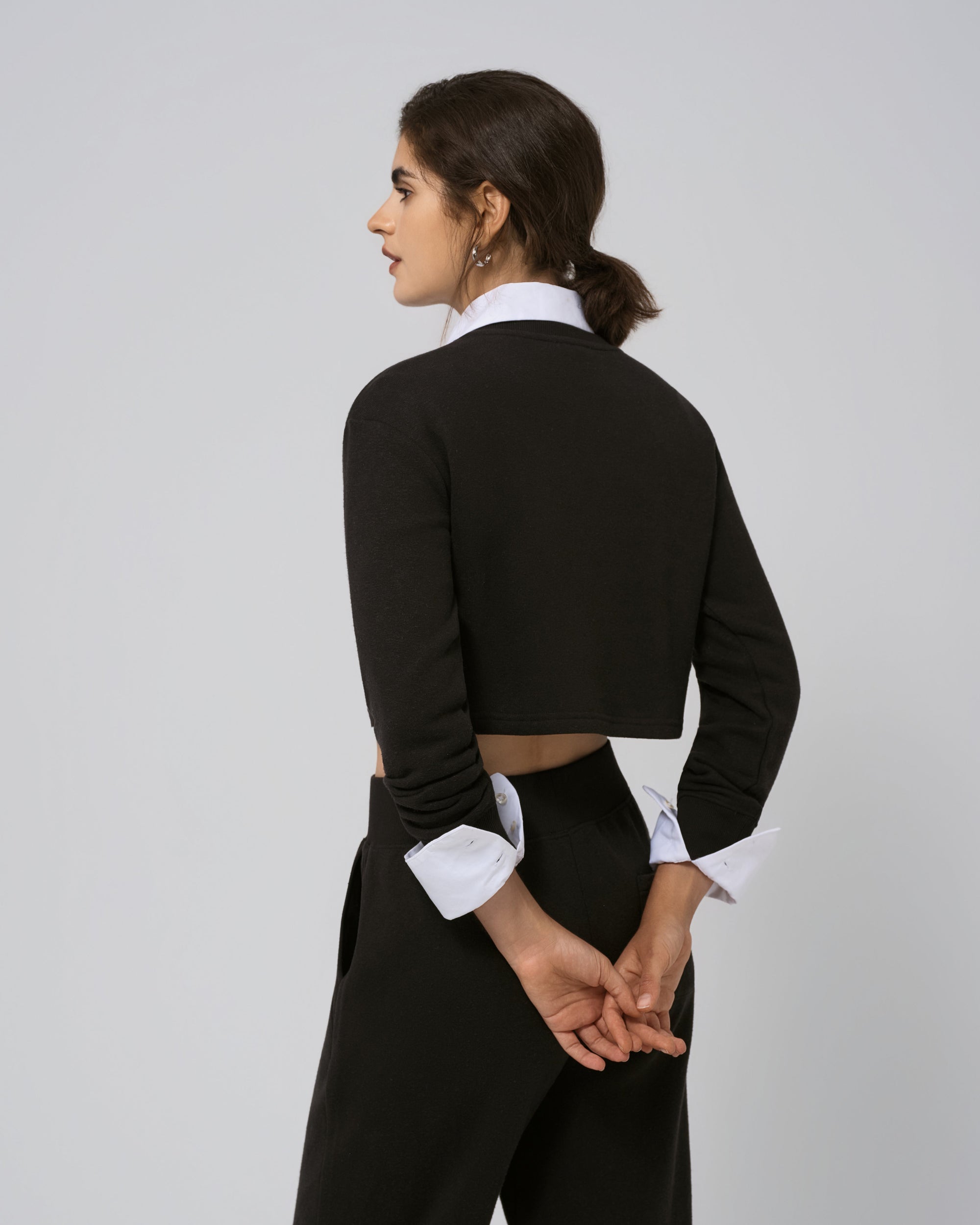 Back view of Off Hours Crewneck Sweater in black; smooth back panel and ribbed hem.