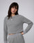 Woman wearing Juana Off Hours Crewneck Sweater in a hemp–Tencel™ blend (gray), styled for sustainable everyday wear.
