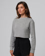 Woman wearing Juana Off Hours Crewneck Sweater in a hemp–Tencel™ blend (gray), styled for sustainable everyday wear.