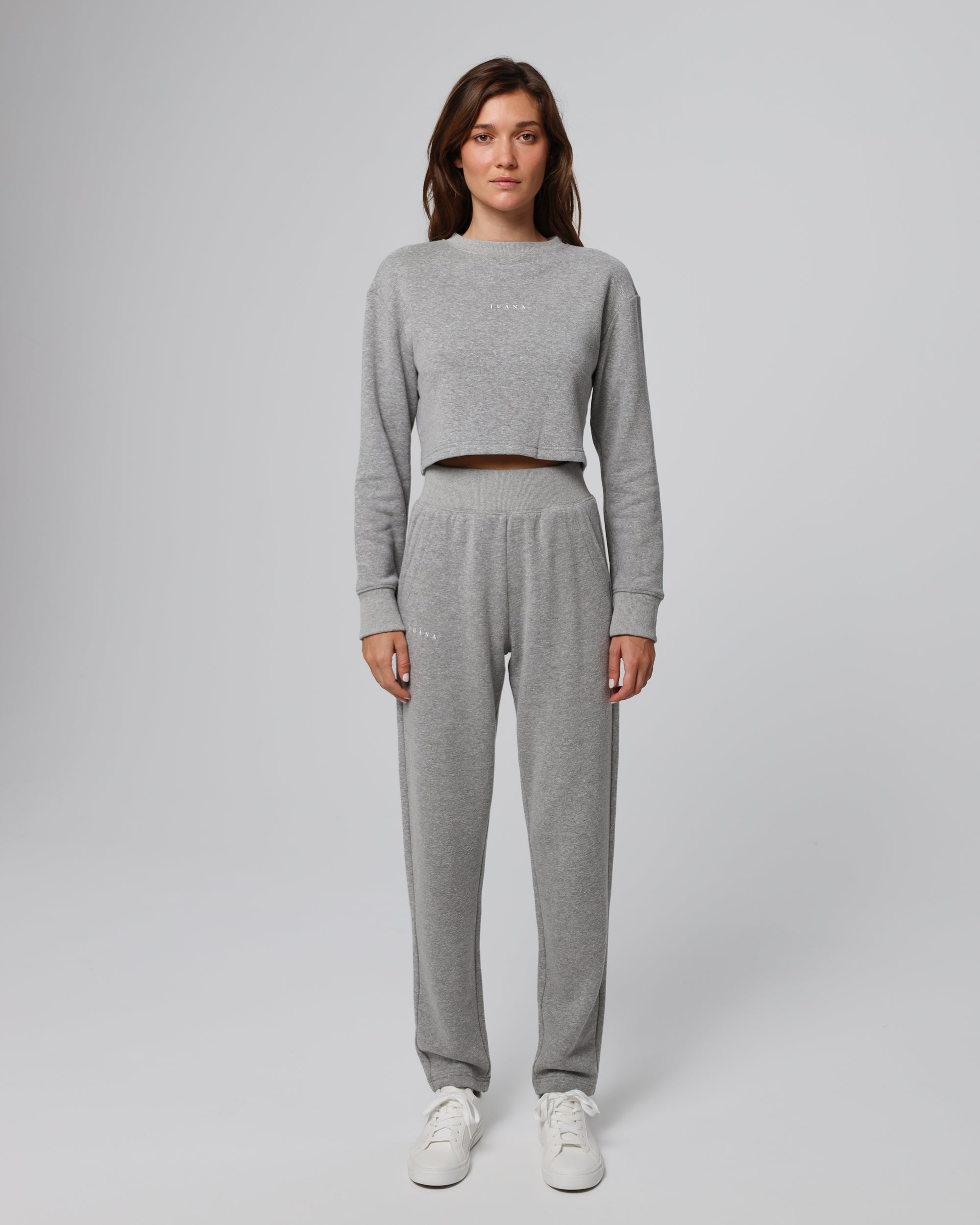 Woman wearing Juana Off Hours Mid Rise Joggers in a hemp–Tencel™ blend (grey), styled for sustainable everyday wear.