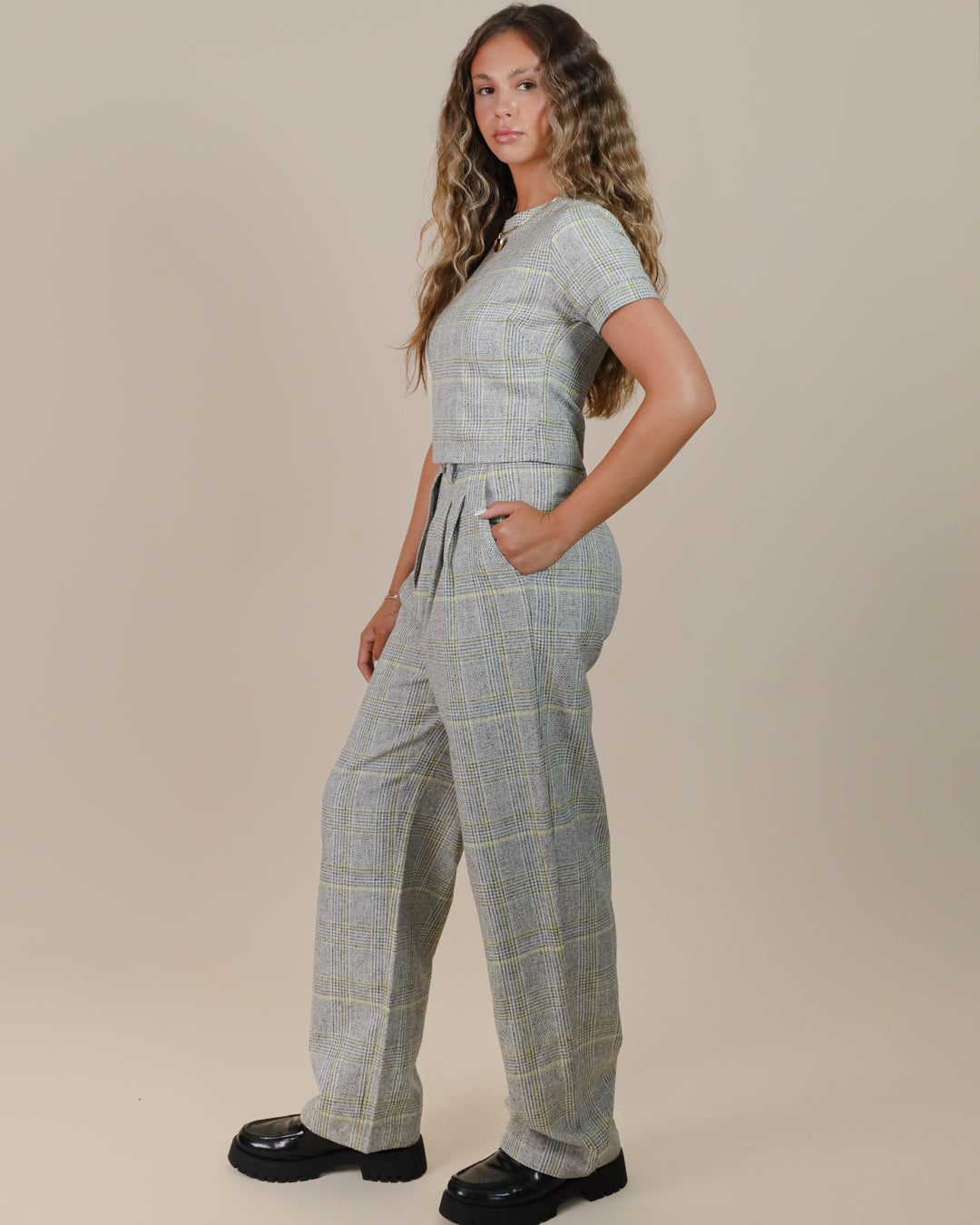 Close-up of Juana Plaid Theory High Rise Trousers highlighting plaid weave and corozo button detailing.