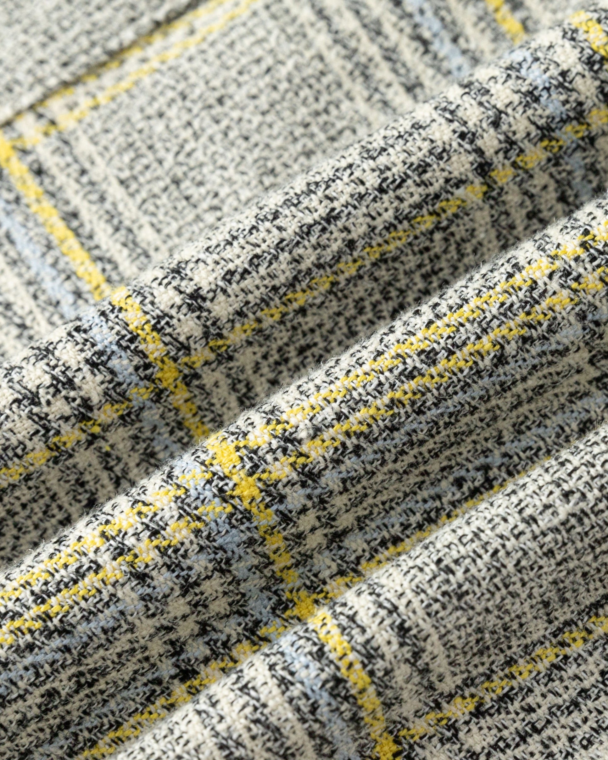 Close-up of hemp–organic cotton plaid fabric of Plaid Theory Top (yellow-grey plaid), highlighting weave and handfeel.