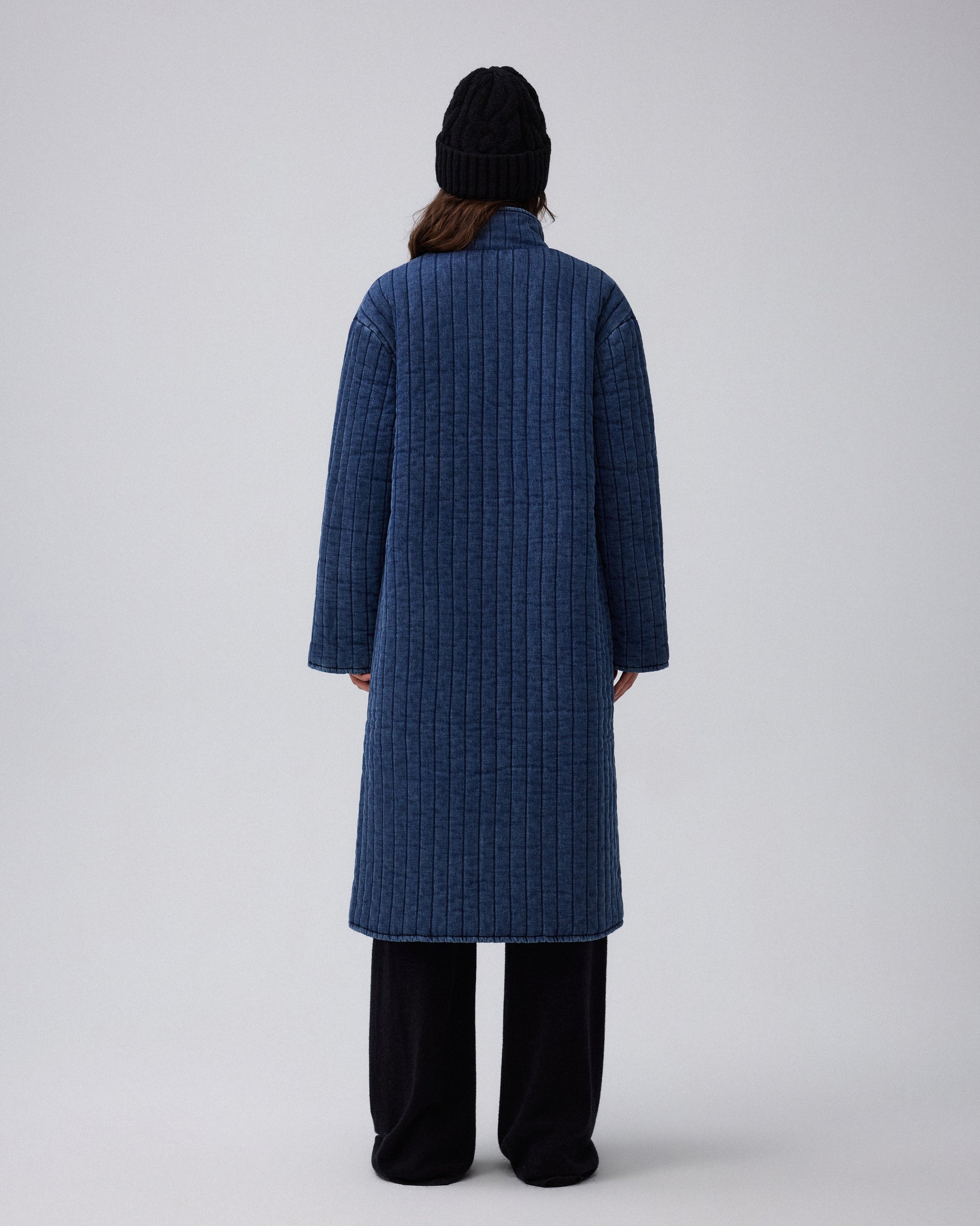 Juana Quilted Denim Jacket in Indigo Wash (organic cotton–hemp) shown from the back with full quilting and a clean structured silhouette.