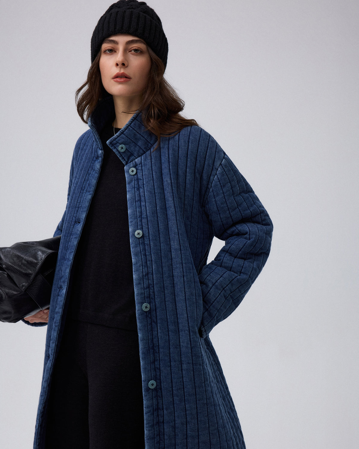 Juana Quilted Denim Jacket in Indigo Wash (organic cotton–hemp) styled on a model as an everyday layered look with front pockets visible.