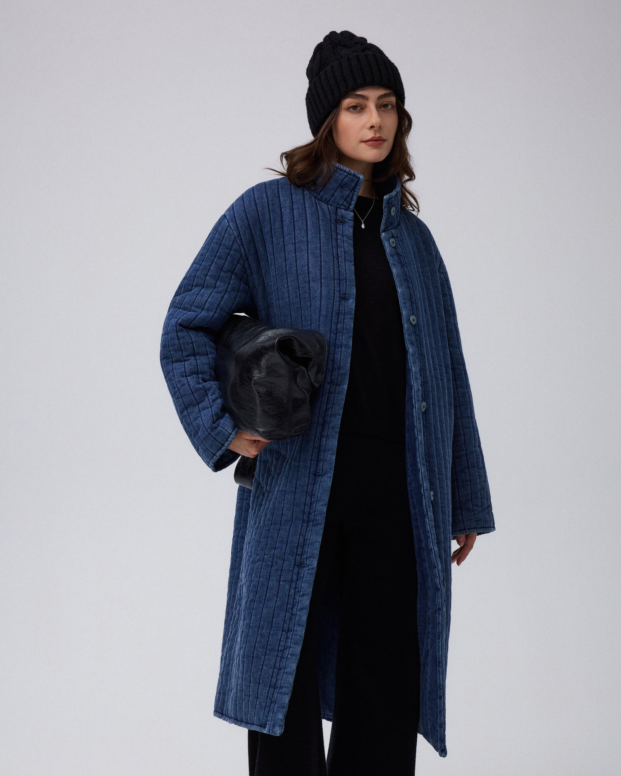 Juana Quilted Denim Jacket in Indigo Wash (organic cotton–hemp) worn on a model with the coconut button front and quilted texture visible.