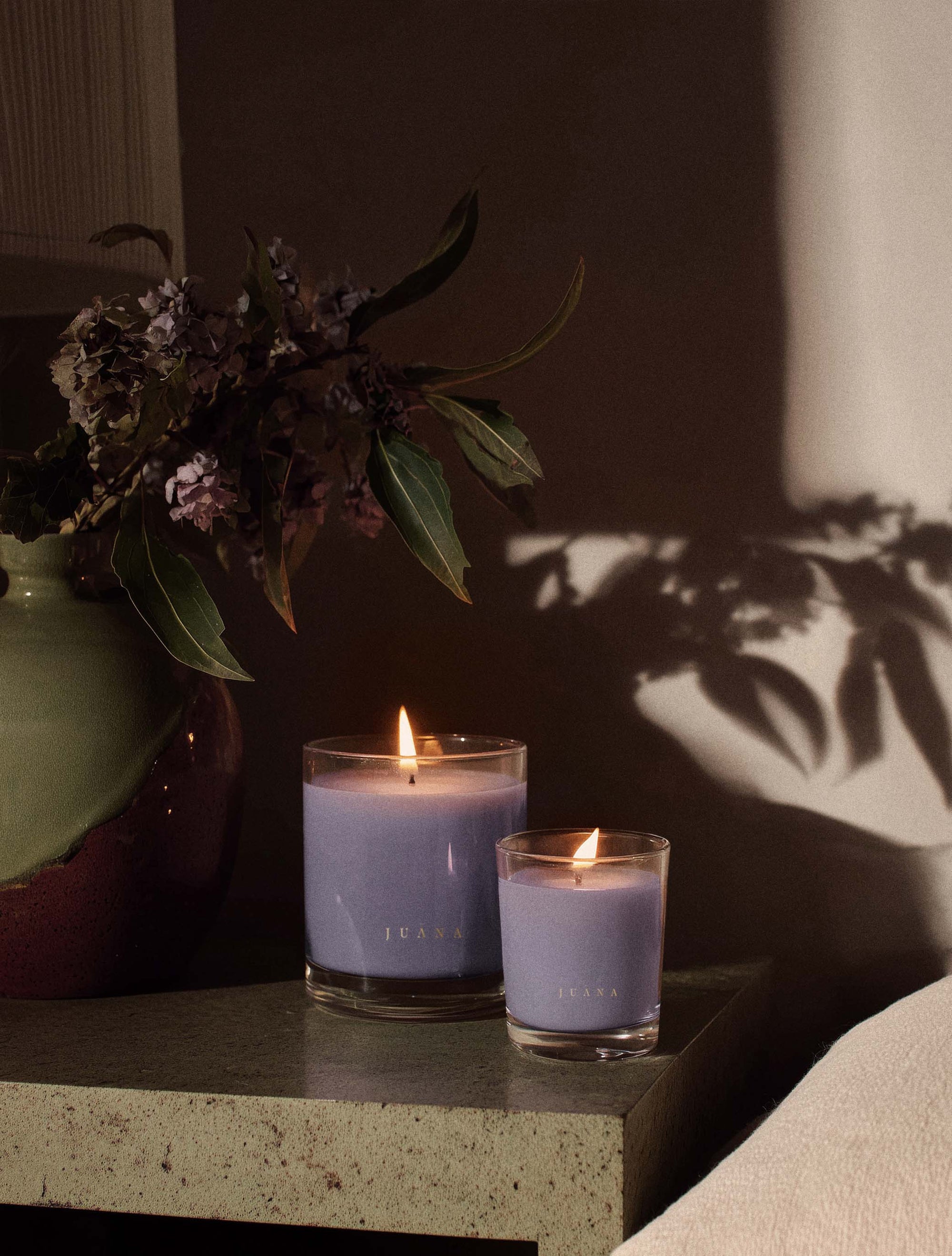 Juana Sandalwood + Hashish Rest apothecary candles in two sizes on decorated table, vegan and eco-friendly.