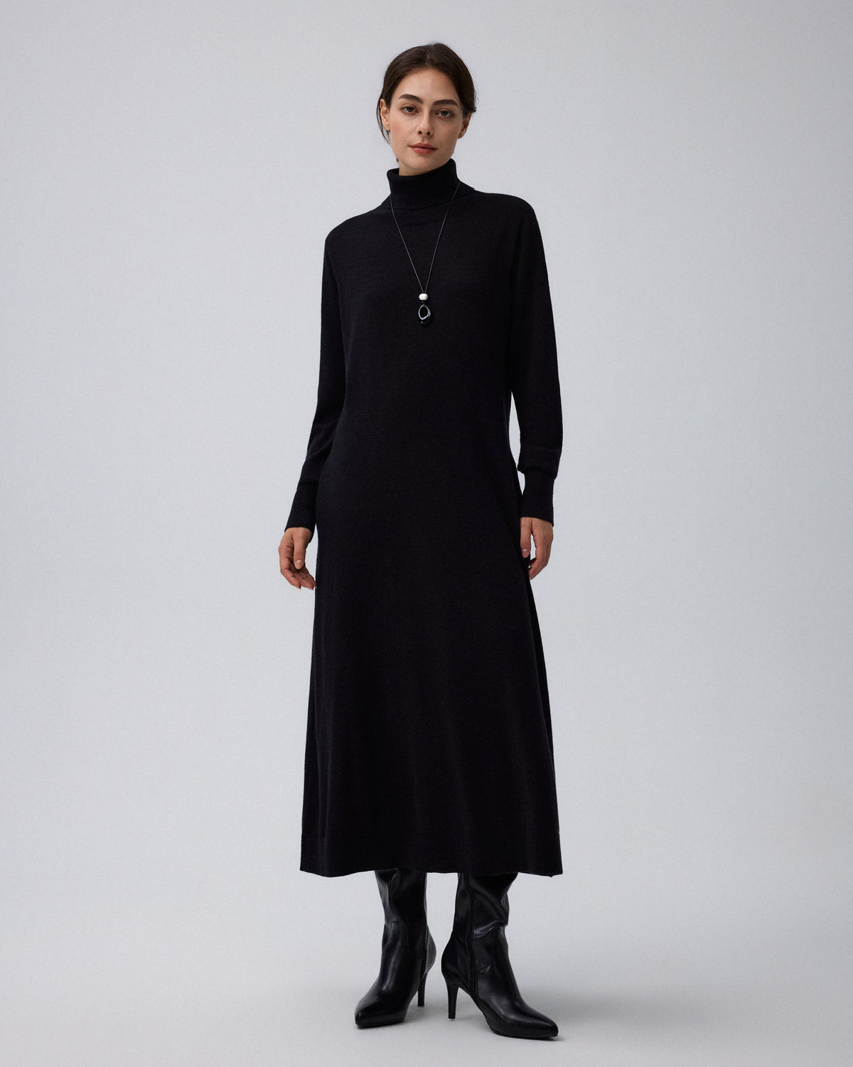 Juana Turtleneck Maxi Dress in Black (merino wool–hemp–silk blend) styled as a complete look with its full-length silhouette visible.