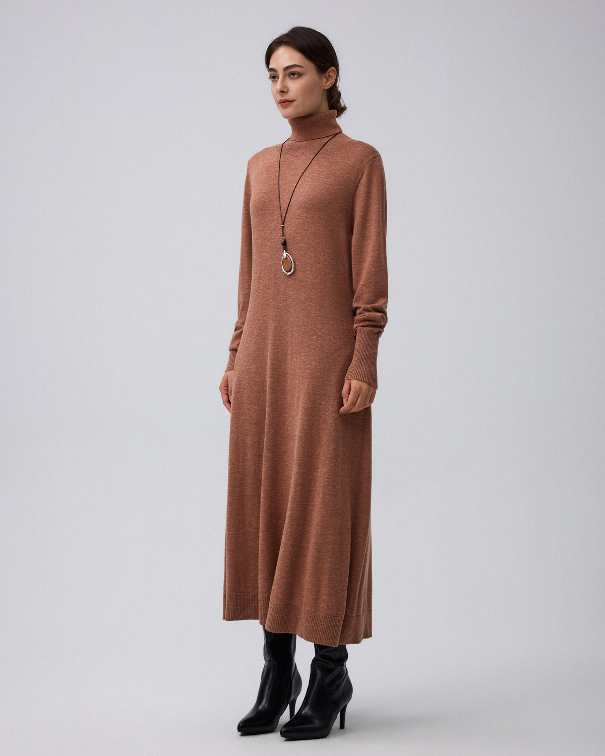 Juana Turtleneck Maxi Dress in Chestnut (merino wool–hemp–silk blend) modeled from the side with the deep side pocket and fluid skirt visible.