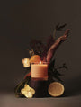 Juana Bergamot + Sativa Uplift apothecary medium candle with ikebana-inspired botanical arrangement, vegan coco-apricot wax, eco-friendly.