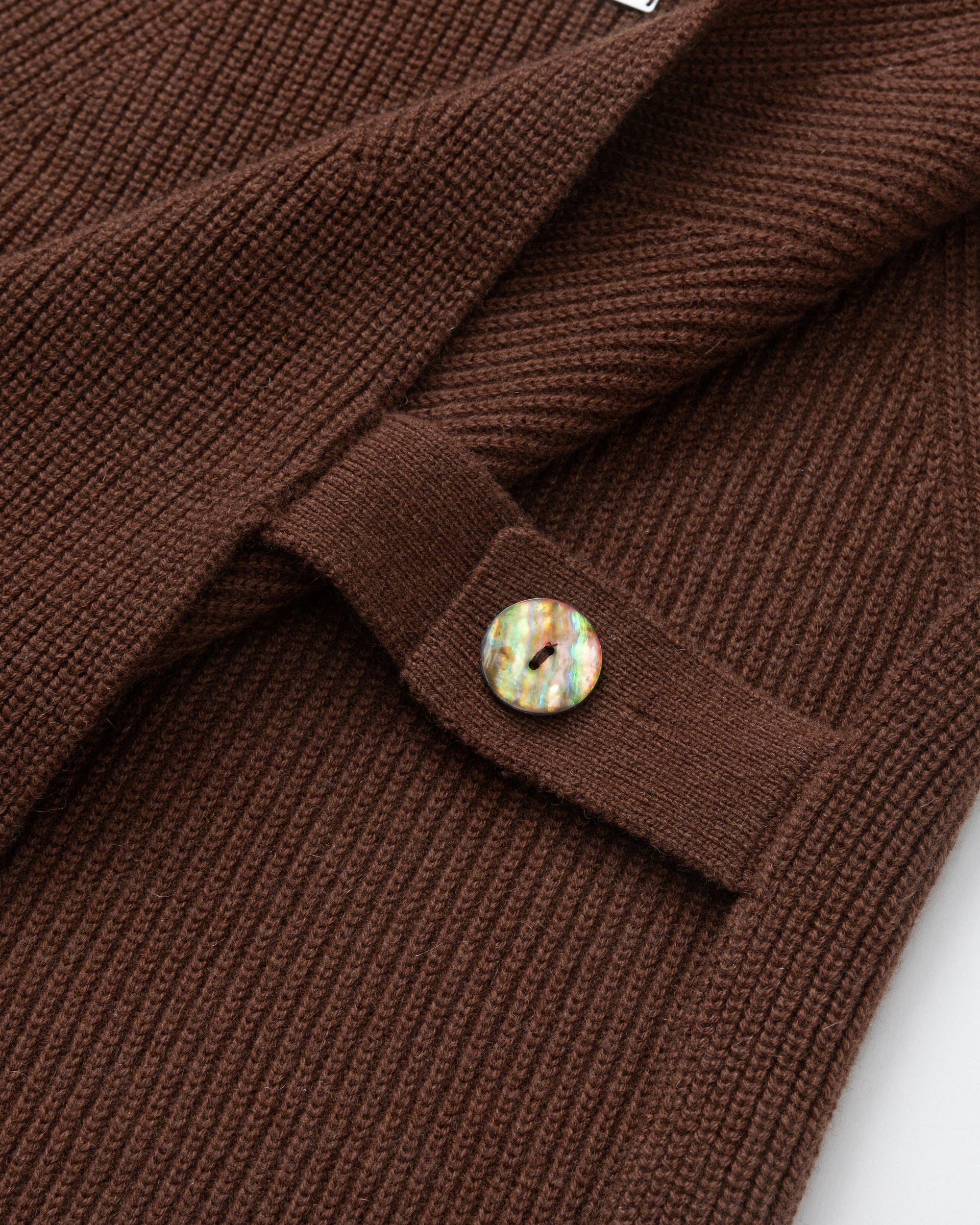 Juana Wool Cashmere Sweater Vest in Chocolate (wool–cashmere) shown in a detail layflat with adjustable abalone shell side straps.
