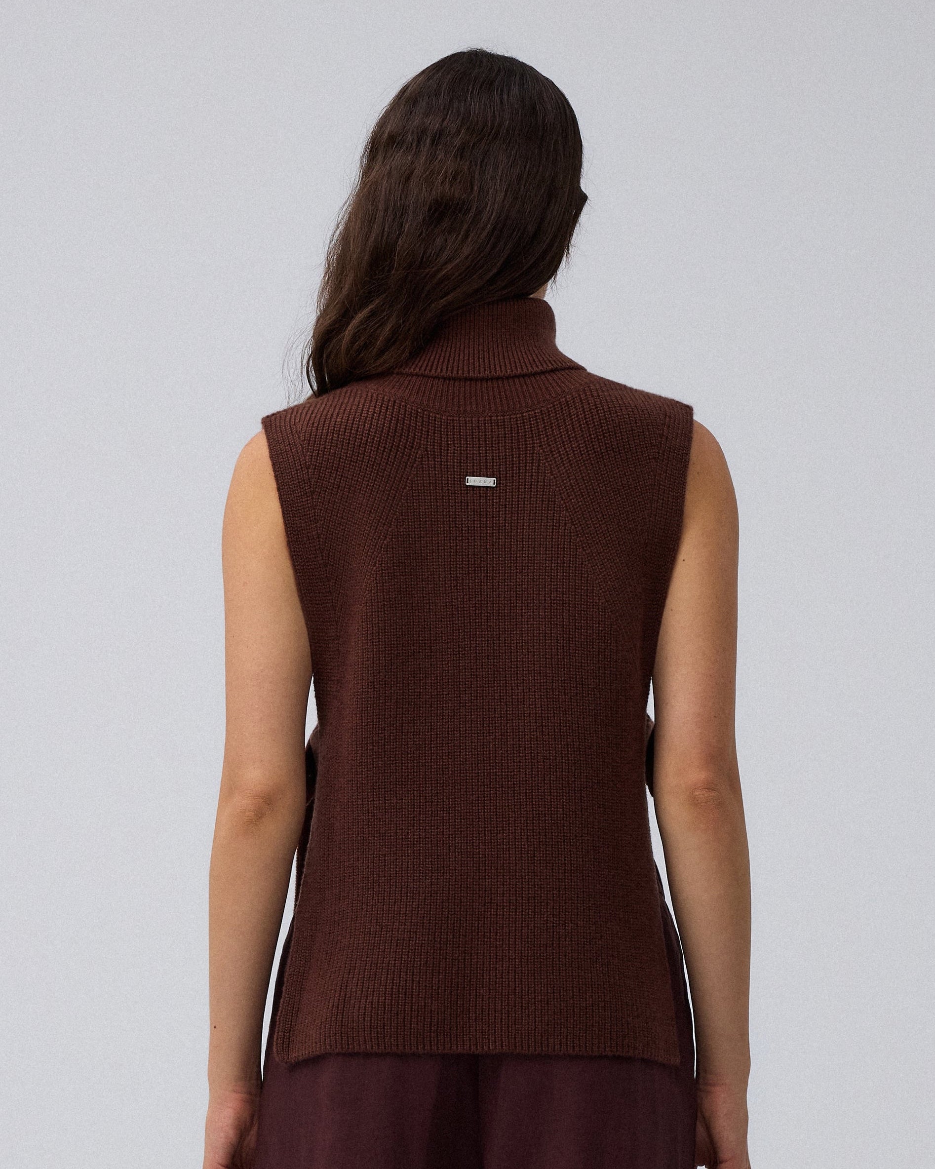 Juana Wool Cashmere Sweater Vest in Chocolate (wool–cashmere) worn in a back view showing the stepped hem.