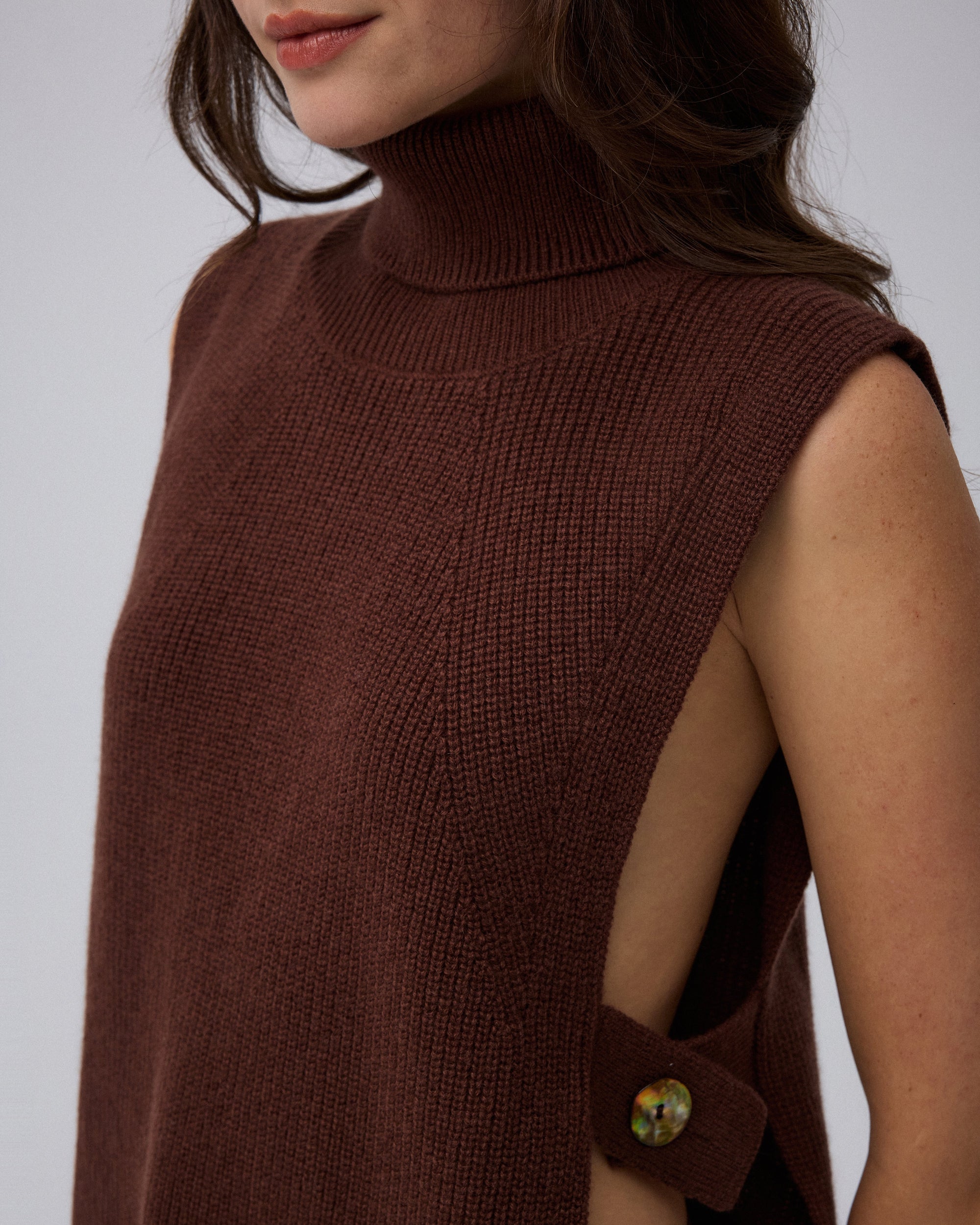 Juana Wool Cashmere Sweater Vest in Chocolate (wool–cashmere) shown in a close-up highlighting the abalone shell hardware and rib knit.