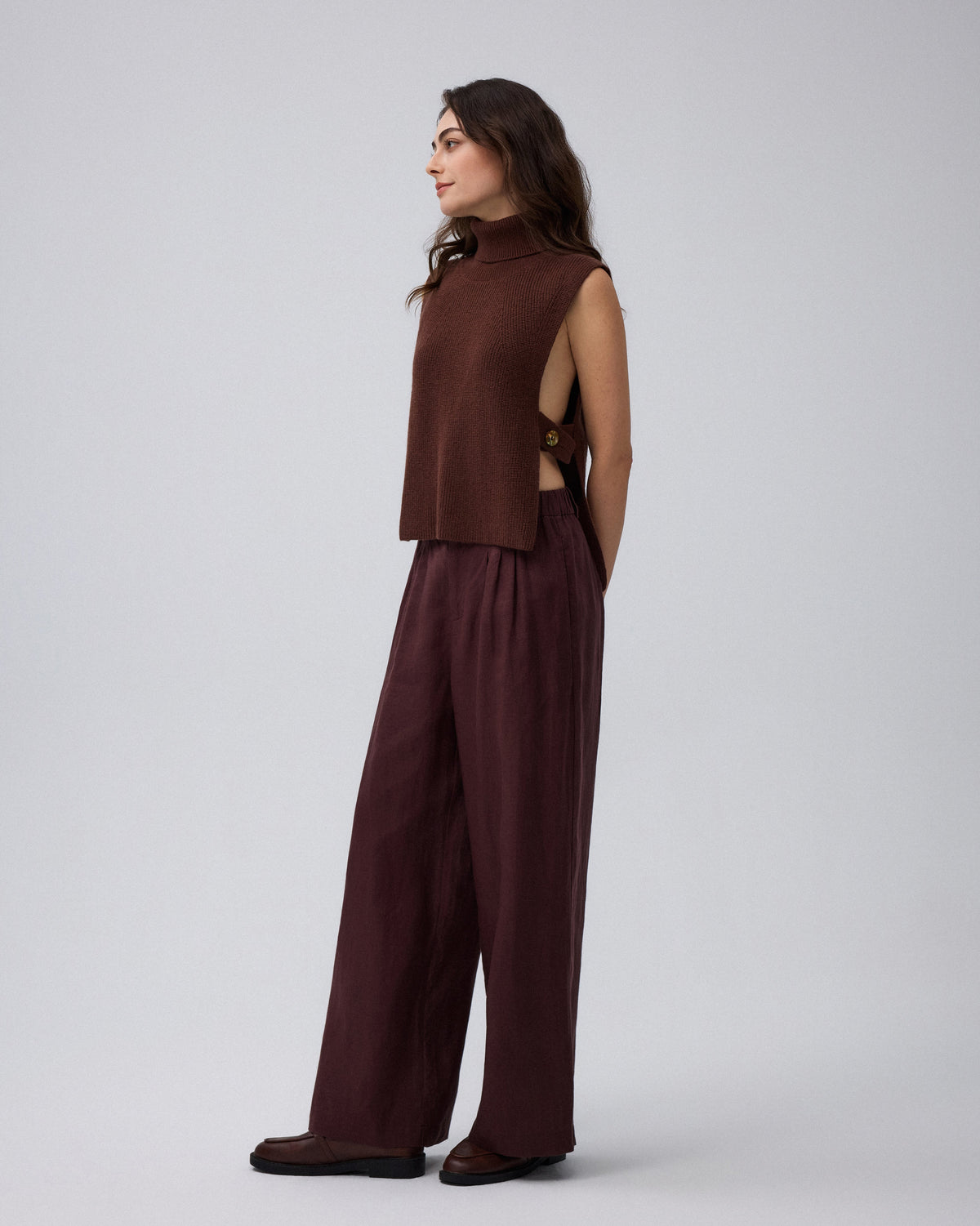 Juana Wool Cashmere Sweater Vest in Chocolate (wool–cashmere) worn in a side view showing the open side and adjustable strap.