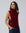 Juana Wool Cashmere Sweater Vest in Pomegranate (wool–cashmere) styled over a lightweight shirt with the shell side straps visible.