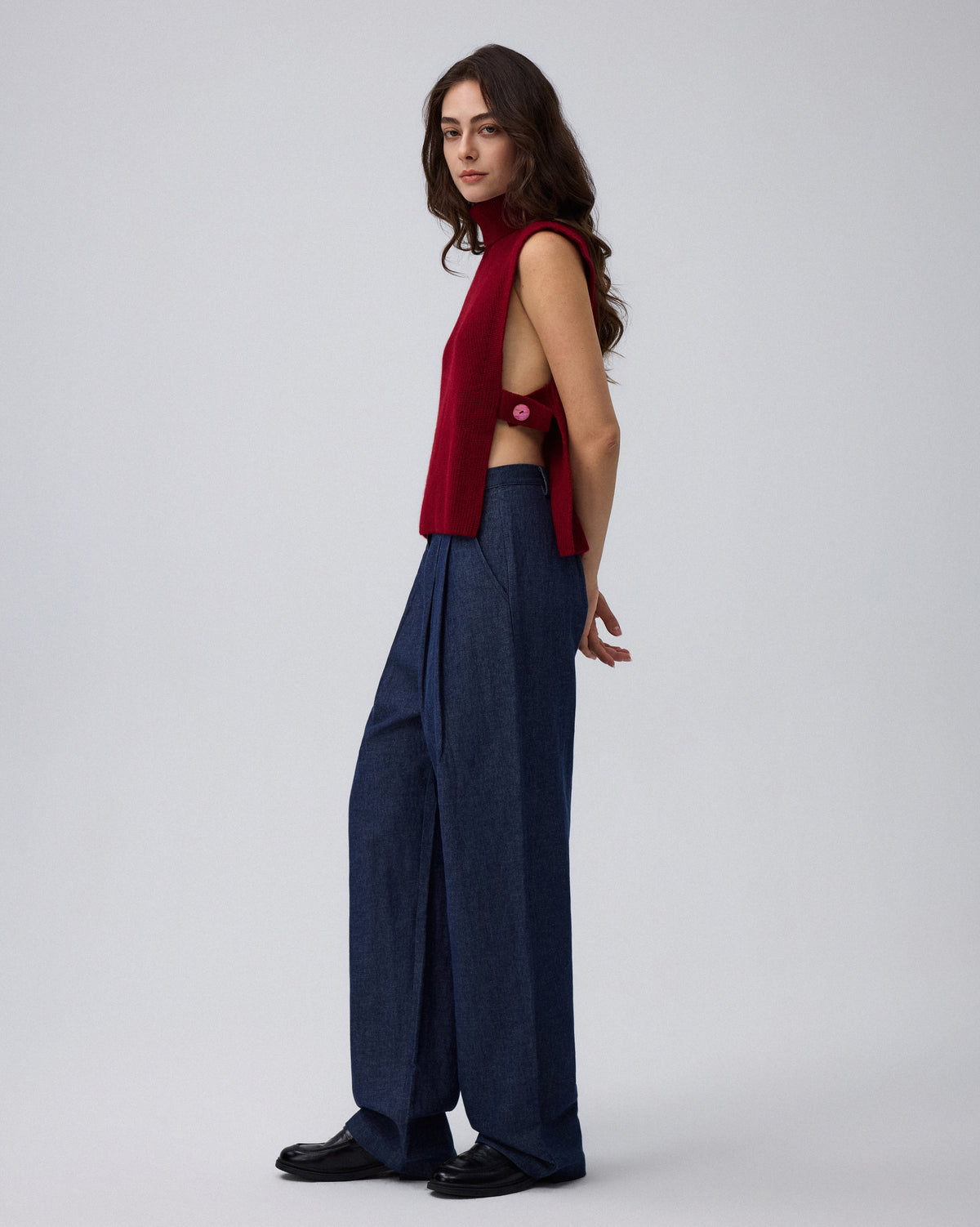 Juana Wool Cashmere Sweater Vest in Pomegranate (wool–cashmere) styled in an elevated layered look with the high neckline visible.
